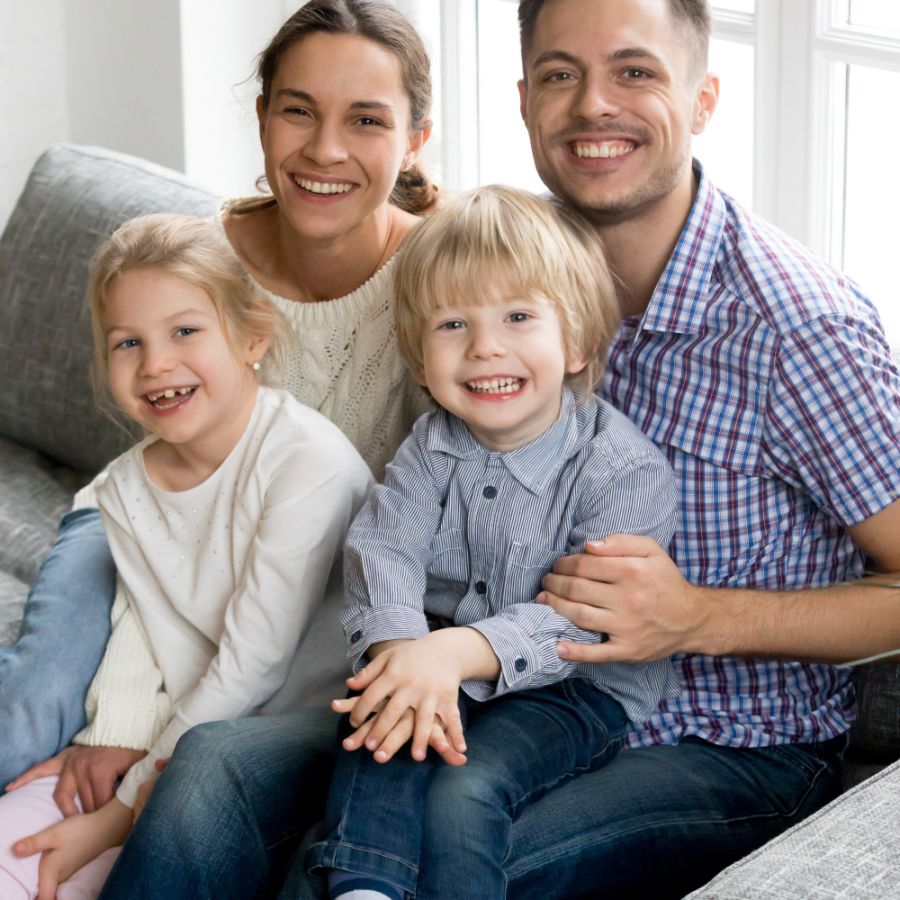 New happy parents for two adopted kids, family vertical portrait