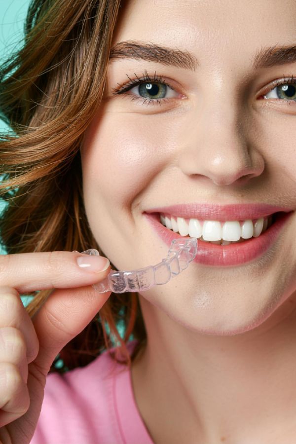 Woman smiling with invisalign clear aligners